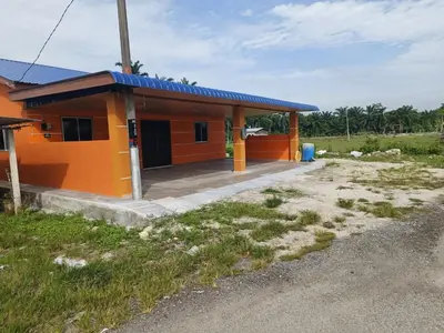 a small orange house with a blue roof at NHR Harmoni in Simpang Ampat