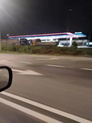 a blurry picture of a gas station at night at Homestay Lyn Impian in Tanjung Rambutan
