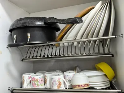 a shelf with cups and utensils in a kitchen at Royal Comfort Suite Meritus near swimming pool in Perai