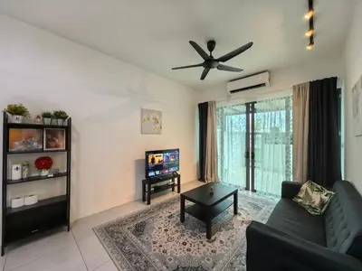 a living room with a couch and a ceiling fan at Royal Comfort Suite Meritus near swimming pool in Perai