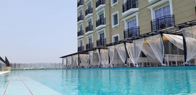 a large swimming pool in front of a building at KF Homestay Premium Suite in Kampar