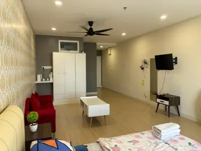 a living room with a couch and a ceiling fan at KF Homestay Premium Suite in Kampar