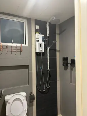 a bathroom with a shower and a toilet in it at KF Homestay Premium Suite in Kampar