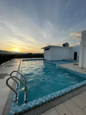 a swimming pool on the roof of a building at D'Anggun Studio in Gua Musang