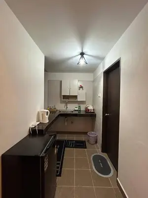 a kitchen with a sink and a counter top at D'Anggun Studio in Gua Musang
