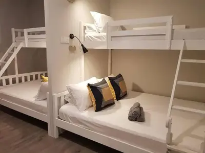 two white bunk beds with pillows on them in a room at Heritage Studio in UNESCO Zone near to StreetArt & Town 1 in George Town