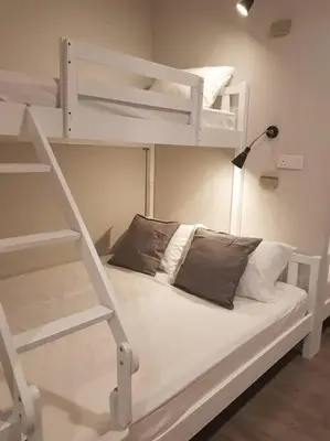 a bedroom with two bunk beds and a lamp at Heritage Studio in UNESCO Zone near to StreetArt & Town 1 in George Town