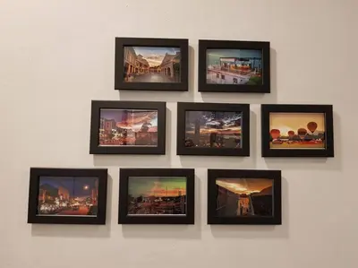 a group of framed pictures on a wall at Heritage Studio in UNESCO Zone near to StreetArt & Town 1 in George Town