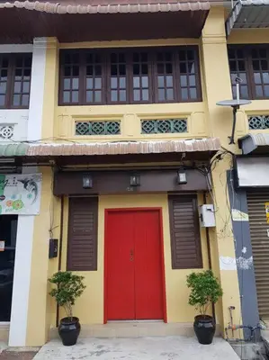 a yellow and red building with a red door at Heritage Studio in UNESCO Zone near to StreetArt & Town 1 in George Town