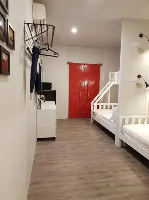 a room with two beds and a red door at Heritage Studio in UNESCO Zone near to StreetArt & Town 1 in George Town