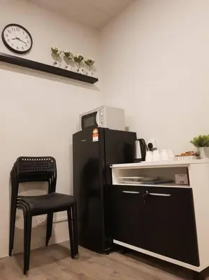 a kitchen with a black refrigerator and a chair at Heritage Studio in UNESCO Zone near to StreetArt & Town 2 in George Town