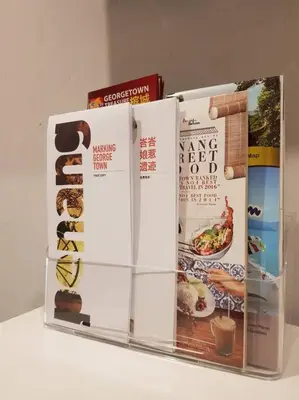 a group of books sitting on top of a counter at Heritage Studio in UNESCO Zone near to StreetArt & Town 2 in George Town