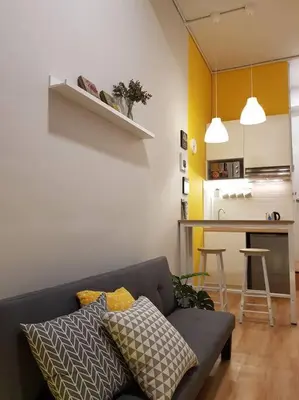 a living room with a couch and a kitchen at Heritage Loft on Beach Street near UNESCO Zone & Street Art 1 in George Town
