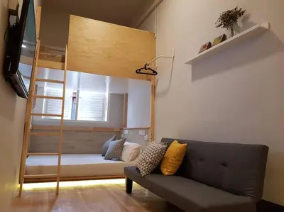 a living room with a couch and a bunk bed at Heritage Loft on Beach Street near UNESCO Zone & Street Art 1 in George Town