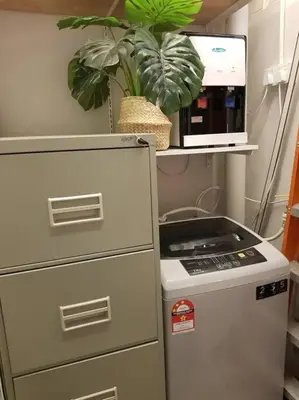 a kitchen with a refrigerator and a plant on a shelf at Heritage Loft on Beach Street near UNESCO Zone & Street Art 1 in George Town