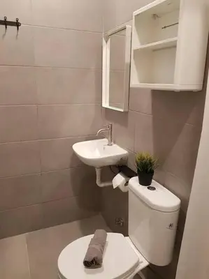 a small bathroom with a toilet and a sink at Heritage Loft on Beach Street near UNESCO Zone & Street Art 2 in George Town