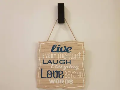 a sign that says life every important laugh involuntary love between words at Heritage Loft on Beach Street near UNESCO Zone & Street Art 3 in George Town