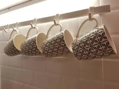 a row of four cups on a rack in a bathroom at Heritage Loft on Beach Street near UNESCO Zone & Street Art 3 in George Town