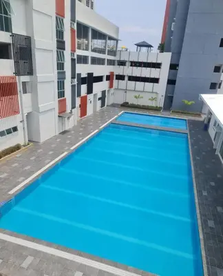 a large swimming pool on the side of a building at Kamilia Homestay Anderson Ipoh in Kampong Simee