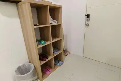 a room with a book shelf with shoes in it at Kamilia Homestay Anderson Ipoh in Kampong Simee