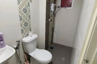 a small bathroom with a toilet and a sink at Kamilia Homestay Anderson Ipoh in Kampong Simee