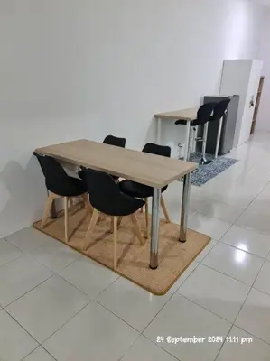 a wooden table with black chairs around it at Kamilia Homestay Anderson Ipoh in Kampong Simee
