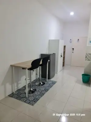 a room with a table and chairs on a tiled floor at Kamilia Homestay Anderson Ipoh in Ipoh