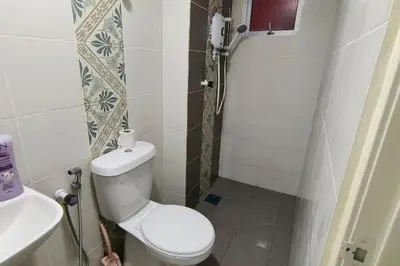 a small bathroom with a toilet and a sink at Kamilia Homestay Anderson Ipoh in Ipoh