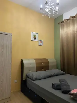 a bedroom with a bed with a chandelier at Nature's Sanctuary at Tanah Rata in Tanah Rata