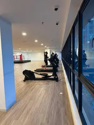a gym with people exercising in the middle of a room at Mini Studio in Batu Kawan in Batu Kawan