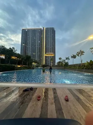 a large swimming pool in front of a tall building at Mini Studio in Batu Kawan in Batu Kawan