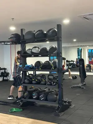 a man standing in a gym with a rack ofgear at Mini Studio in Batu Kawan in Batu Kawan