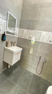 a bathroom with a sink and a mirror at Pearl Castlestay in Tanjung Karang