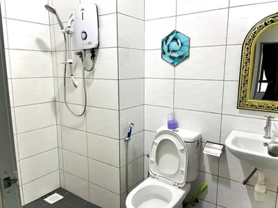 a bathroom with a shower and a toilet and a sink at Ammara Homestay 3 Palas horizon Kea Farm in Cameron Highlands