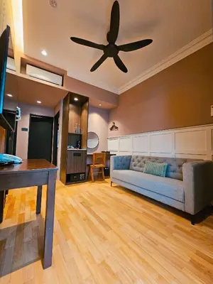 a living room with a couch and a ceiling fan at The Palm Suite at Lava Mansion in George Town