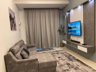 a living room with a couch and a flat screen tv at Rumah teres untuk keluarga in Tanjung Rambutan