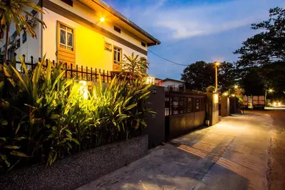 a house with a fence next to a street at Value Inn Homestay by uBook in Butterworth