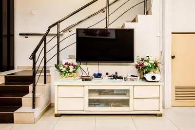 a tv on top of a dresser in a living room at Value Inn Homestay by uBook in Butterworth