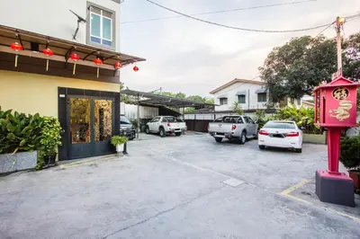 a parking lot with cars parked in front of a building at Value Inn Homestay by uBook in Butterworth