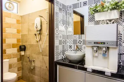 a bathroom with a sink and a toilet at Surprised Homestay by uBook in Butterworth