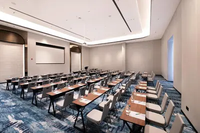 an empty classroom with desks and chairs in a room at Iconic Marjorie Hotel, Penang, a Tribute Portfolio Hotel in Bayan Lepas