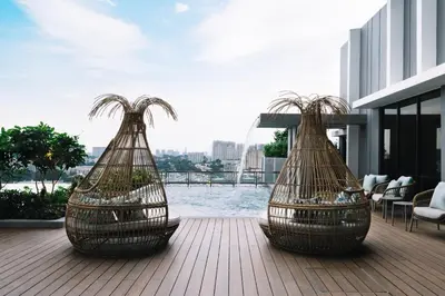 two nets on a deck with a view of the water at Iconic Marjorie Hotel, Penang, a Tribute Portfolio Hotel in Bayan Lepas