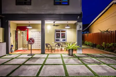 a home patio with a table and chairs at Plumeria 5BR Garden House by uBook in Butterworth