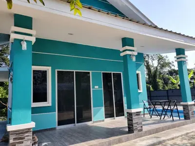 a blue and white house with a patio at Inap Desa Fajar Saujana in Baling