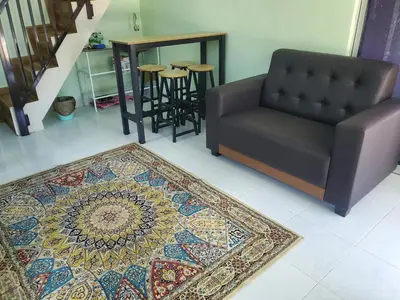 a living room with a couch and a rug at Inap Desa Fajar Saujana in Baling