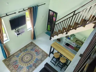 an overhead view of a living room with a tv and stairs at Inap Desa Fajar Saujana in Baling