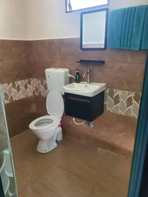 a bathroom with a toilet and a sink at Inap Desa Fajar Saujana in Baling