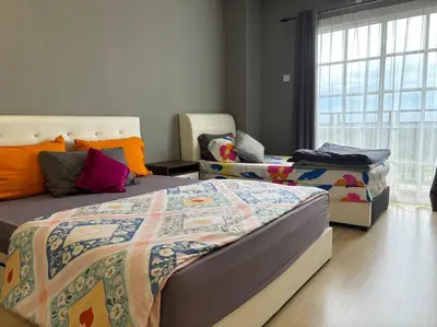 a bedroom with two beds and a window at KF Homestay Double Suite in Kampar