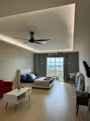 a living room with a bed and a ceiling fan at KF Homestay Deluxe Suite in Kampar