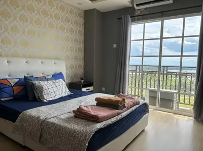 a bedroom with a bed with a view of the ocean at KF Homestay Deluxe Suite in Kampar